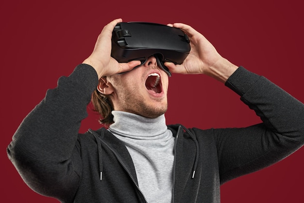 Shocked man exploring cyberspace in vr glasses