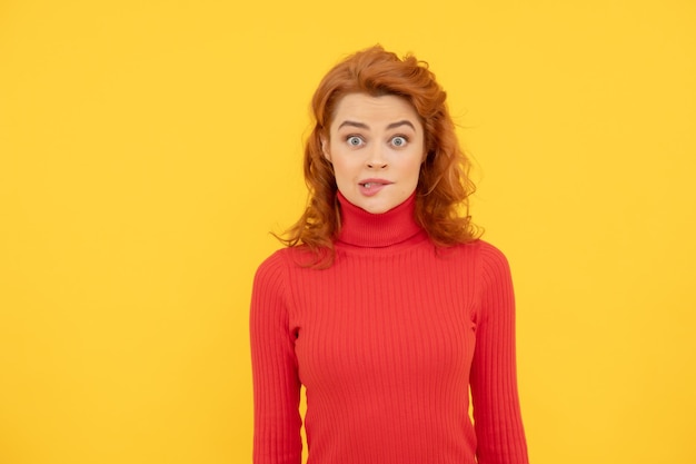 Shocked red haired woman surprised redhead woman on yellow background express human emotions amazed lady with curly hair beauty and fashion female fashion model pretty look of young girl