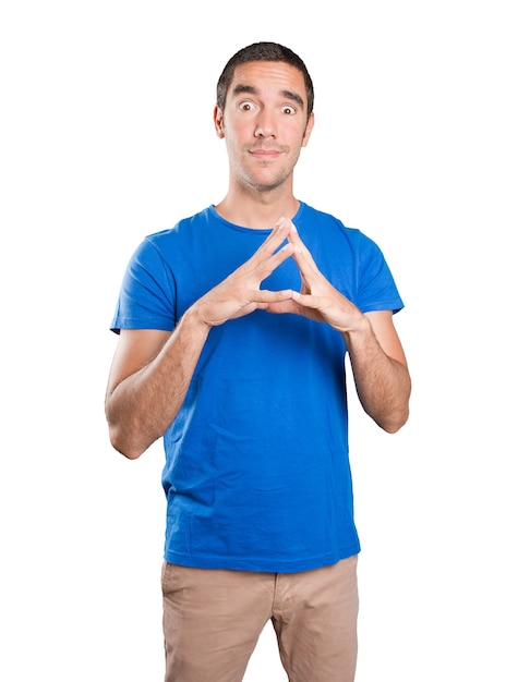 Shocked young man with a gesture of concentration against white background