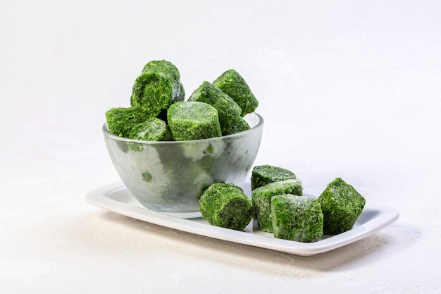 Shockfrozen spinach briquettes are an alternative to fresh produce Concept of healthy eating