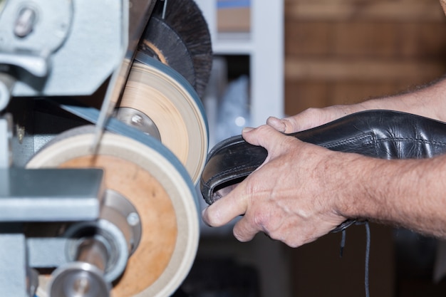 The shoemaker repairs a shoe