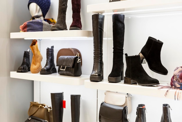 Shoes and bags on a showcase in a store. Autumn-winter collection. Style and fashion. Front view.