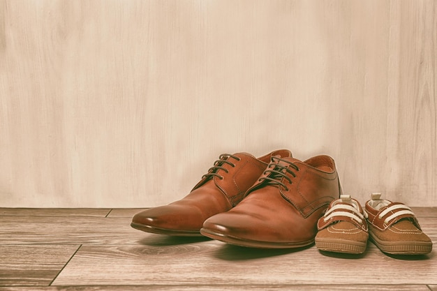 Shoes for father and son on floor