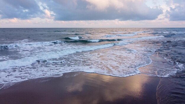 Shooting from a flying drone over the sea with a dramatic sky before a storm