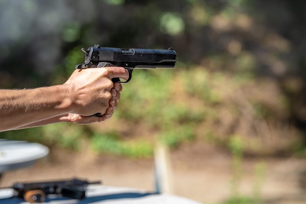 Shooting from a pistol at a target on a shooting range