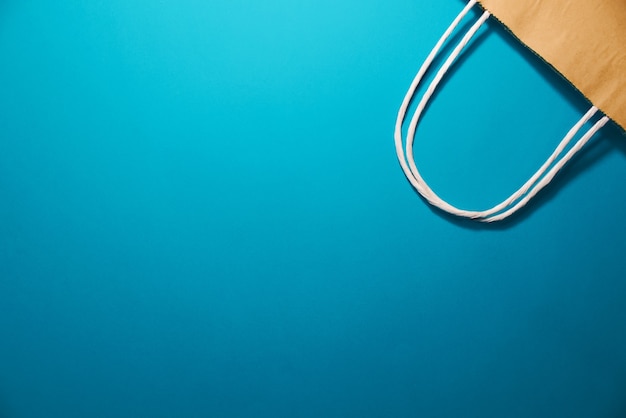 Shopping bag on a blue background, top view. Copy space