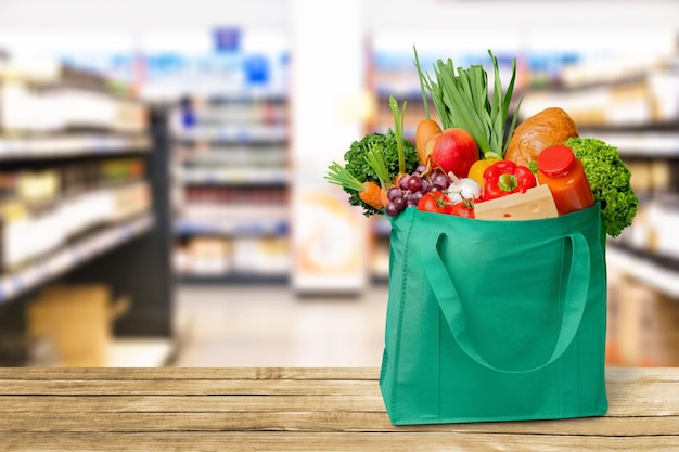 Shopping bag with grocery products isolated on background