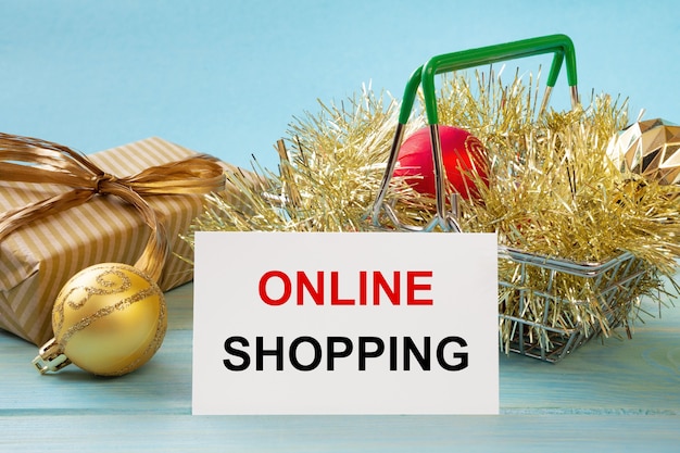 Shopping basket and text ONLINE SHOPPING on white paper note list. Shopping list concept.