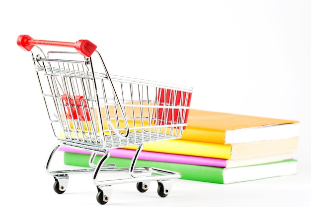 Shopping for Books. Shopping Cart with books on the white background