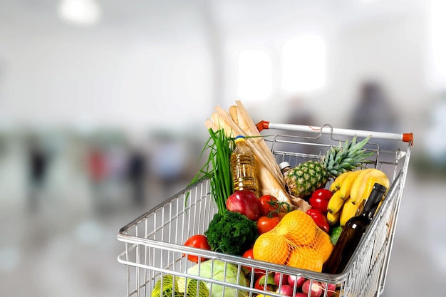 Shopping cart full with various groceries