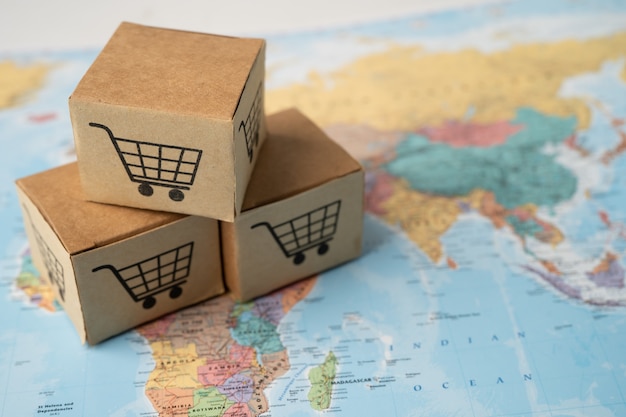 Shopping cart logo on box on world globe map