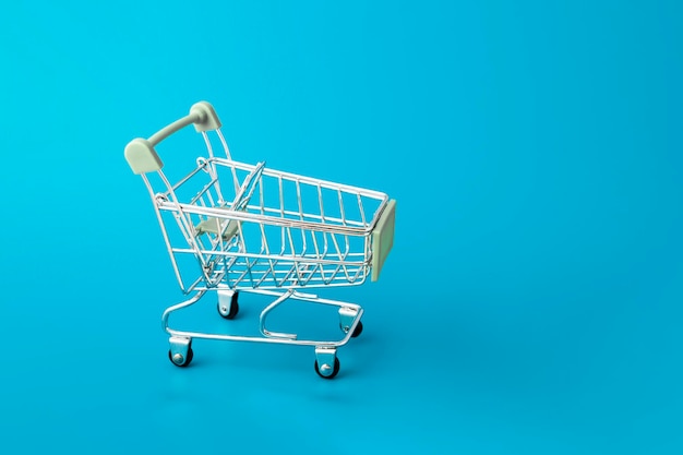 Shopping cart supermarket trolley on blue background