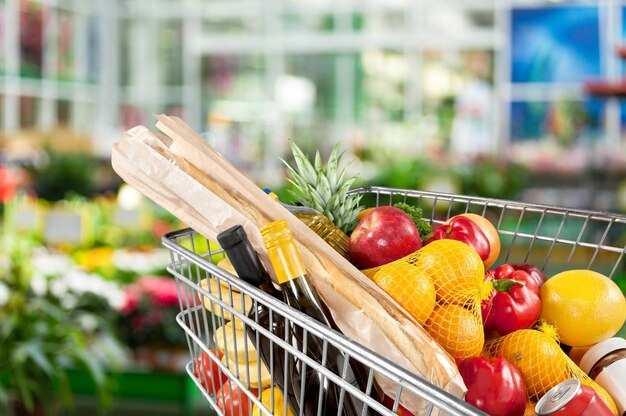 Shopping cart with fruits and vegetables at the market.