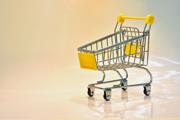 the shopping cart with yellow handle with dollar bankn