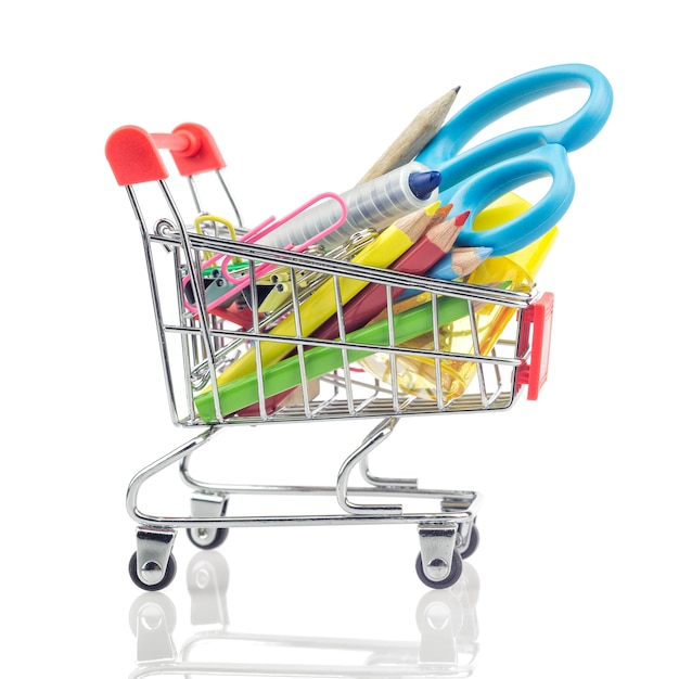 Shopping carts with school supplies isolated on a white