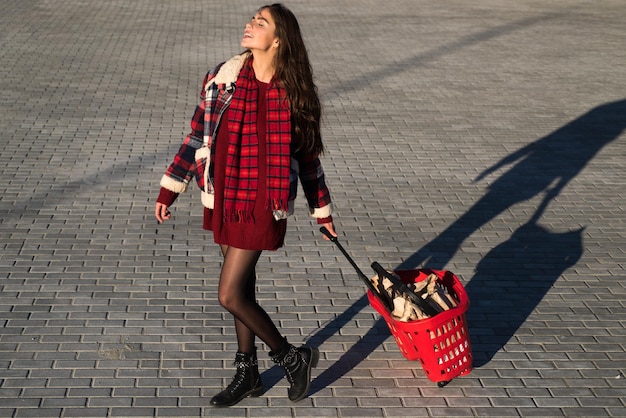 Shopping concept woman with shop cart outdoor