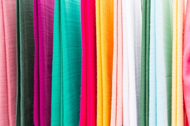 shopping, industry, sale and clothing concept - colorful textile at asian street market