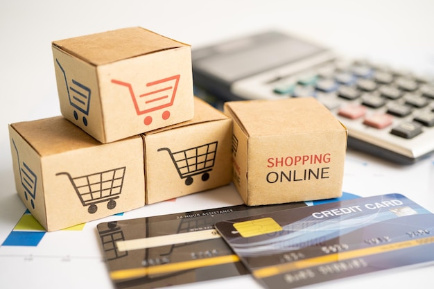 Shopping online box with credit card and calculator on graph Finance commerce import export business concept