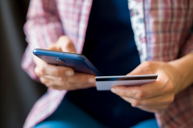 Shopping online from a smartphone and a credit card. 