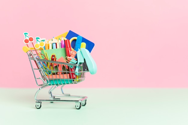 Shopping trolley full of school supplies as preparation to school