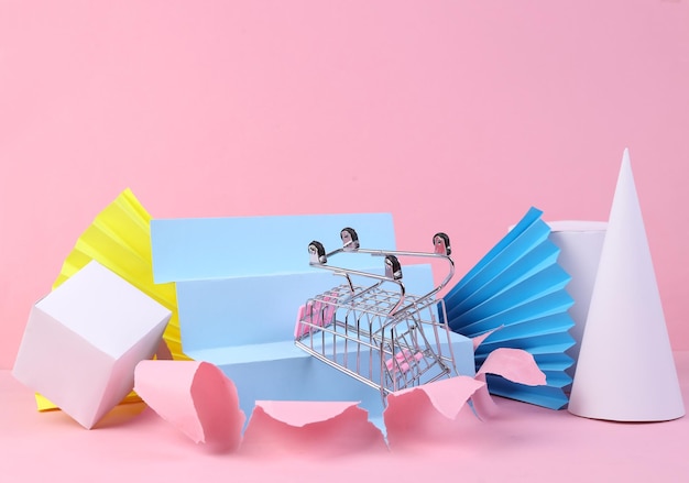 Shopping trolley on pink background with geometric shapes Minmalism Concept art