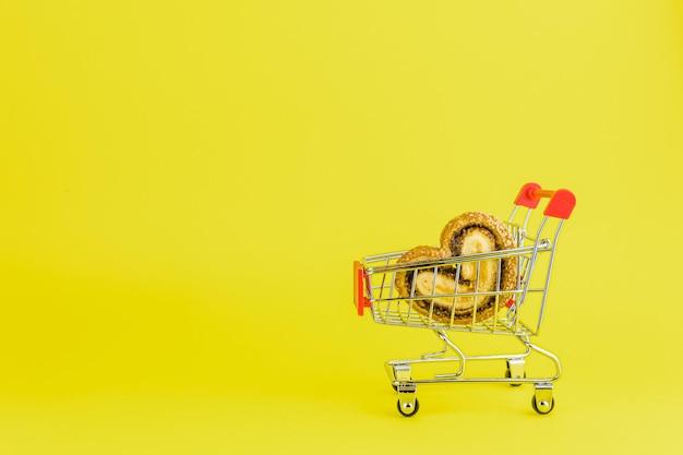 Shopping trolley with heart shaped cookies with copy space