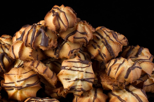 Shortbread cookie with chocolate icing on a dark background