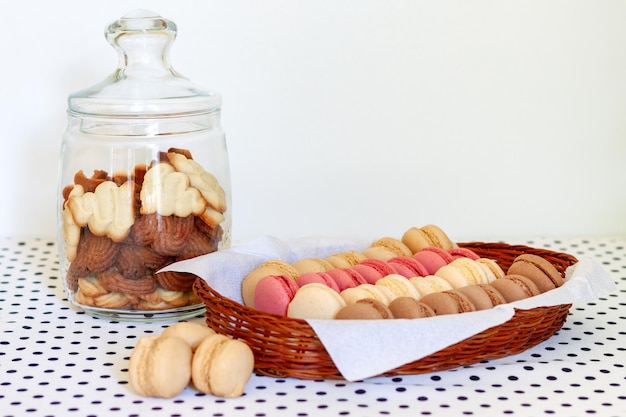 Shortbread cookies in a glass bin and French macaroons in a basket