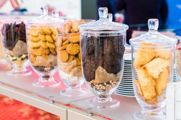 Shortbread cookies in glassware and other sweets on the buffet table during the coffee break