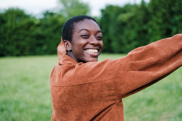 Shorthaired young man with his back turned and smiling with his arms in a sign of happiness