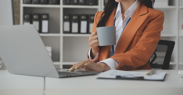 Shot of a asian young business Female working on laptop in her workstation