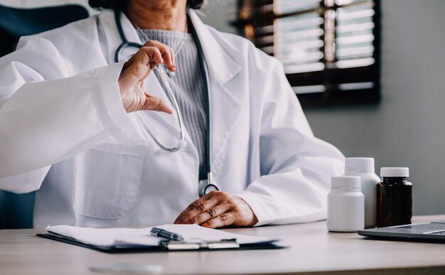 Shot of attractive female doctor working with her computer in medical consultation