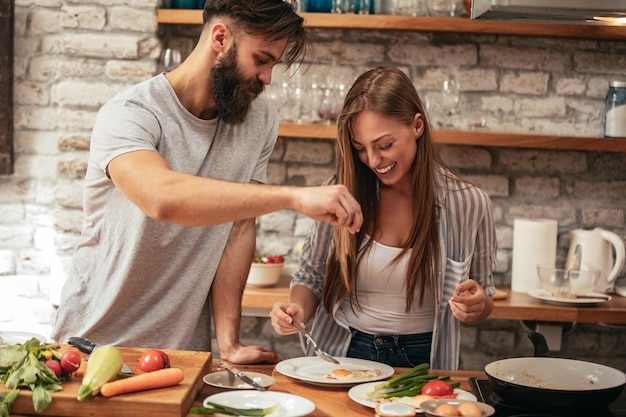 Shot of an attractive young couple cooking in the kitchen