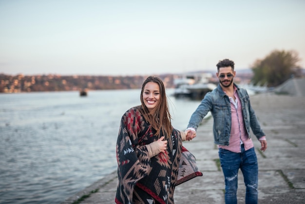 Shot of a beautiful couple walking and having a good time outdoors