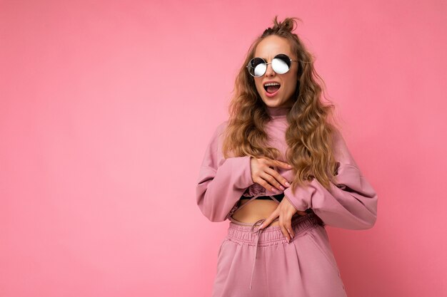 Shot of beautiful happy young dark blonde curly woman isolated 