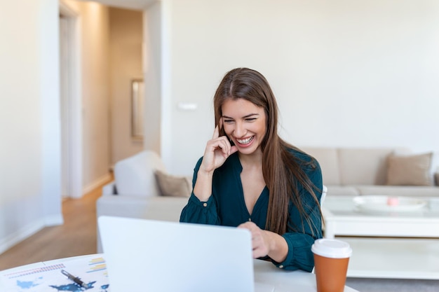 Shot of a businesswoman on a video call while sitting at her deskCropped shot of an attractive young woman using her laptop to make a video call at home