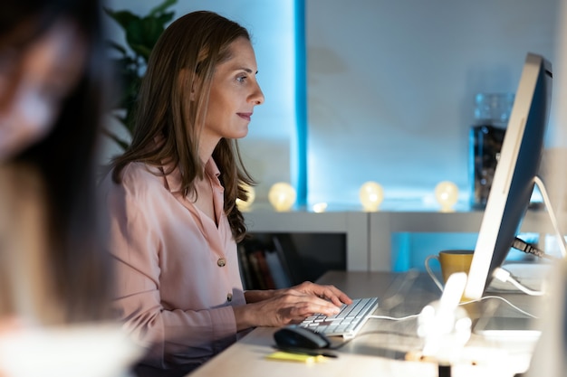 Shot of concentrated mature business woman working with her computer in the office.