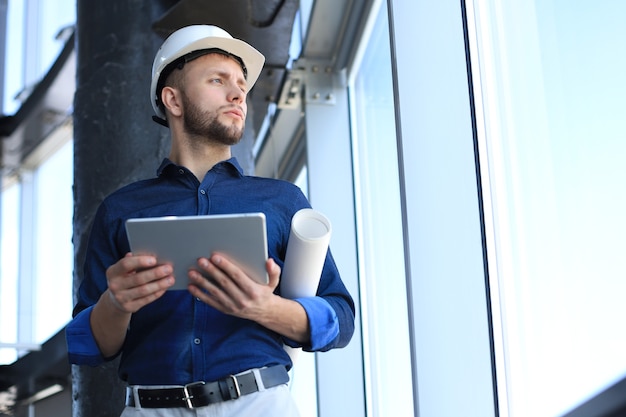 Shot of a engineer using a digital tablet on a construction site. This software help me to keep track of everything.