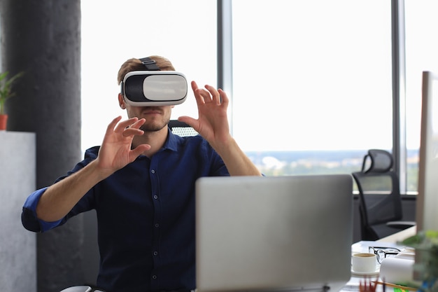 Shot of an engineer wearing a VR headset in an new building. Change the way you see and experience the world.