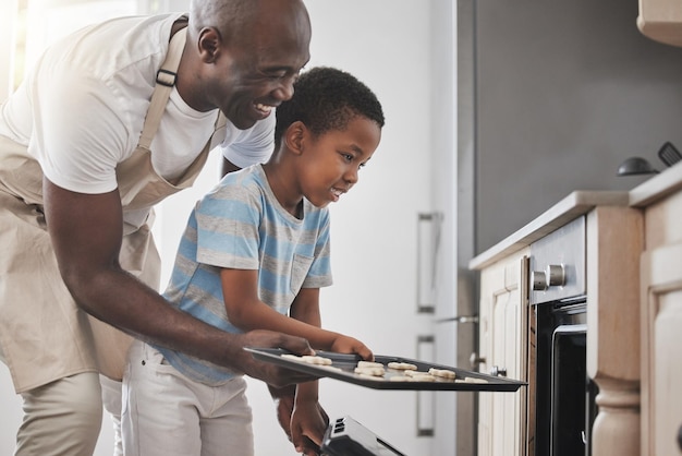 Shot of a father and son standing by the oven in the kitchen