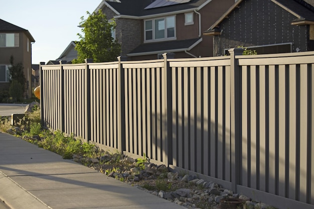 Shot of the fence around the house in the neighborhood during the sunset.