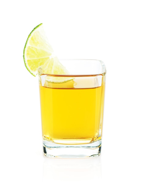 Shot of gold tequila with lime slice