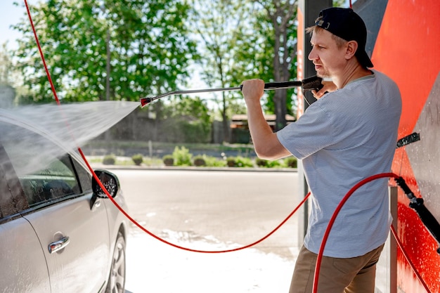 Shot of a man washing his car