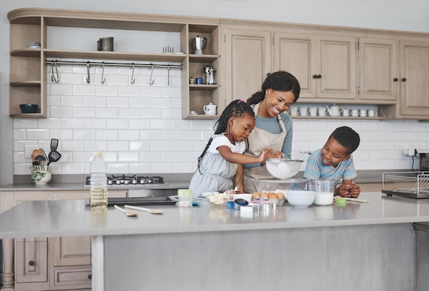 Shot of a mother baking with her children at home