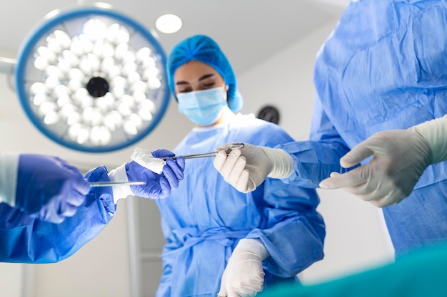 Shot in the Operating Room Assistant Hands out Instruments to Surgeons During Operation Surgeons Perform Operation Professional Medical Doctors Performing Surgery