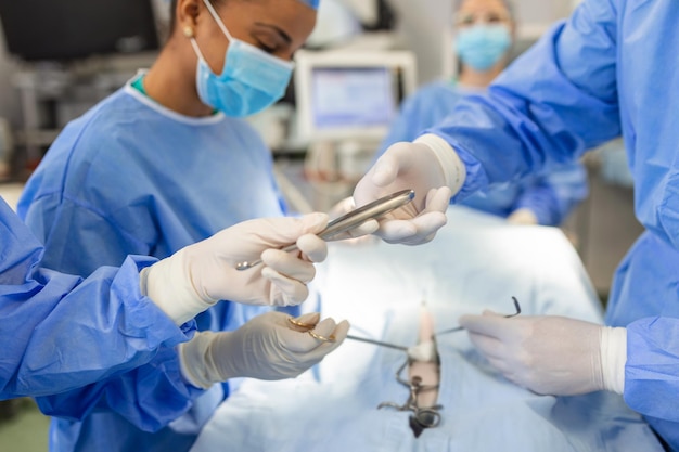 Shot in the Operating Room Assistant Hands out Instruments to Surgeons During Operation Surgeons Perform Operation Professional Medical Doctors Performing Surgery