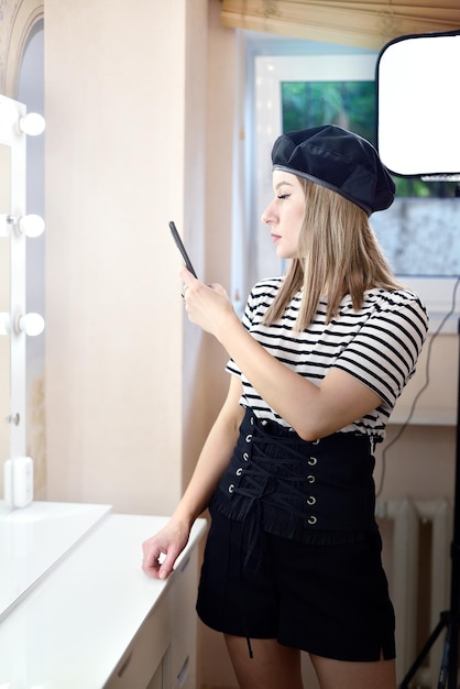 Shot of pretty young woman taking a selfie living room at home