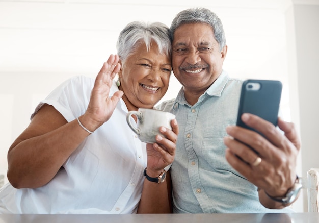 Shot of a senior couple on a call together at home