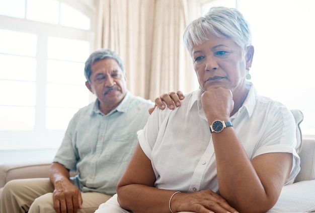 Shot of a senior man consoling his sad wife at home