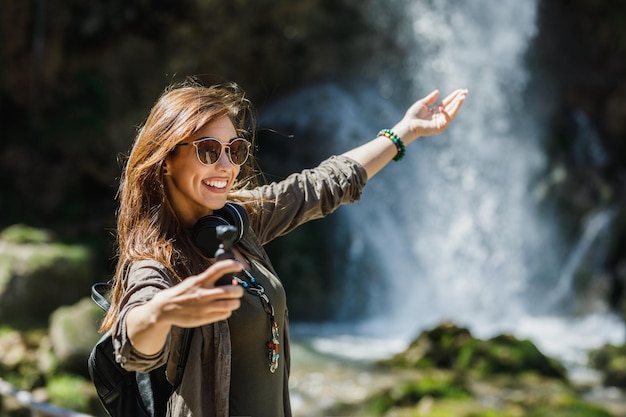 Shot of a smiling young woman enjoying day in nature.